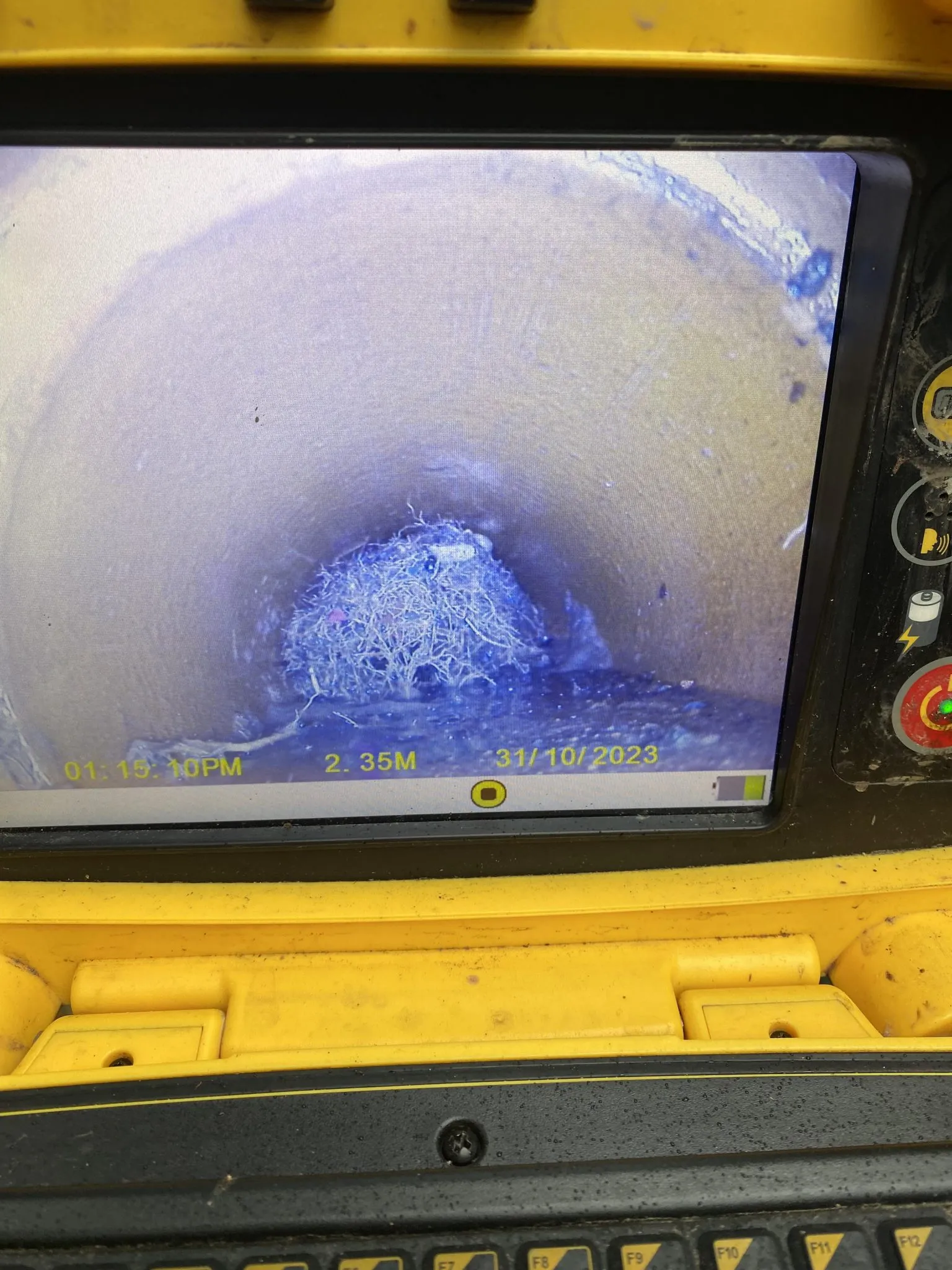 CCTV drain survey monitor showing a blockage in a drainpipe